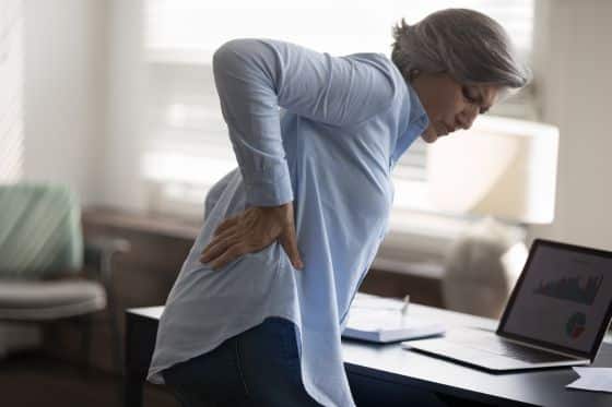 A woman suffers from back pain